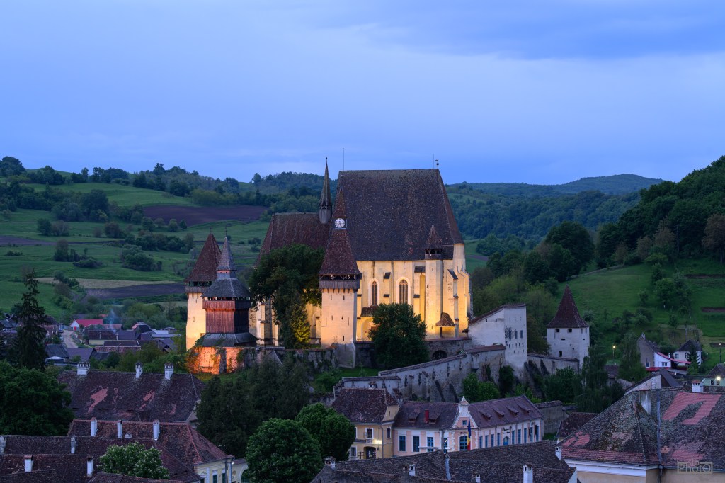 Floodlit towers and walls of Biertan Fortified Church at dusk (96mm, f/7.1, 1/5 sec)
