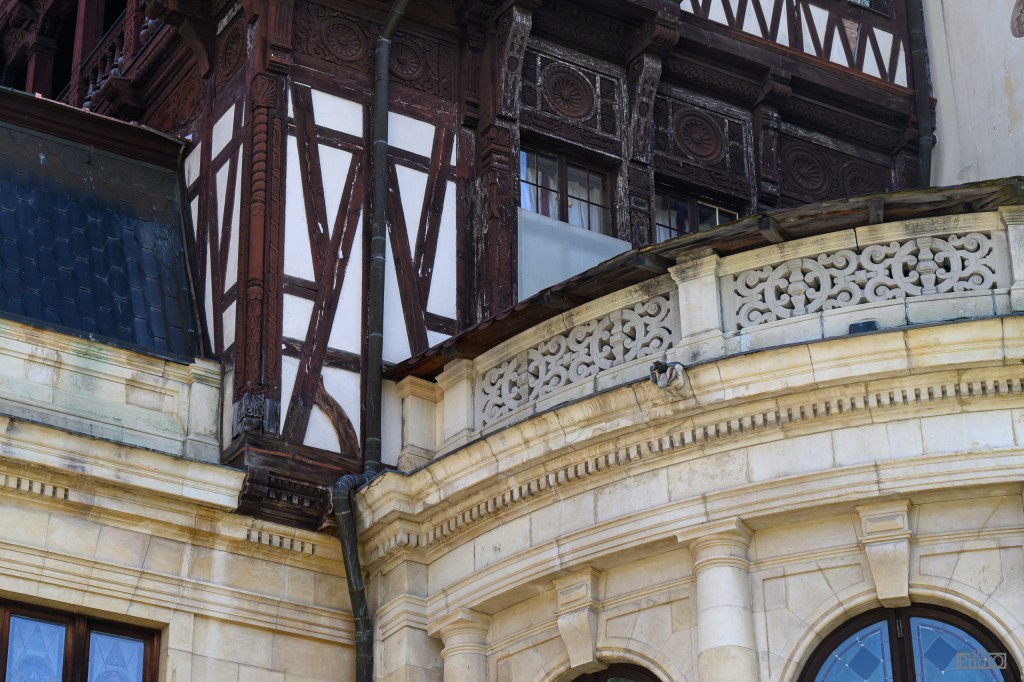 Close-up of architectural details showcasing a blend of wooden beams and stonework on a historic building.